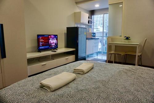 a bedroom with a bed with two pillows on it at Hip & Funky Sathon15 apartment close to BTS St Louis in Bangkok
