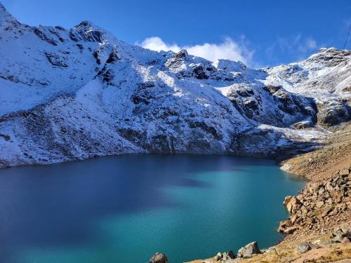 a lake in the middle of a snow covered mountain at Natur Pur Hotel Unterpichl in Ultimo