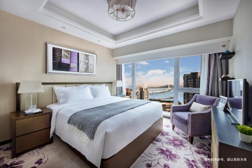 Postel nebo postele na pokoji v ubytování Savills Residence Daxin Shenzhen Bay