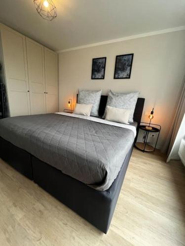 a bedroom with a large bed with two pillows at Charmante Penthouse - Therme Badewelt - Museum in Sinsheim Hoffenheim in Sinsheim