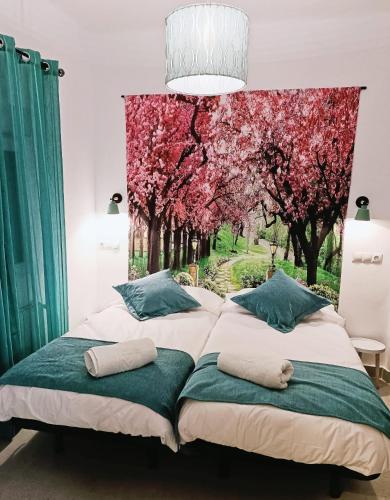 a bedroom with two beds with trees in the background at Violeta Suite in Madrid