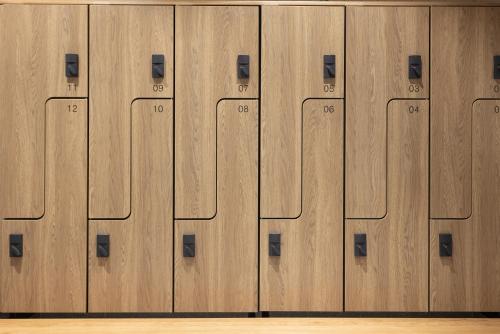 a row of wooden lockers in a gym at Noli Otaniemi in Espoo