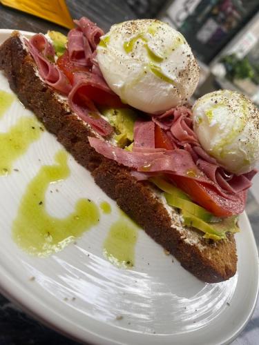 a sandwich on a plate with eggs on it at DWELL - Elegant City Stay in Athens