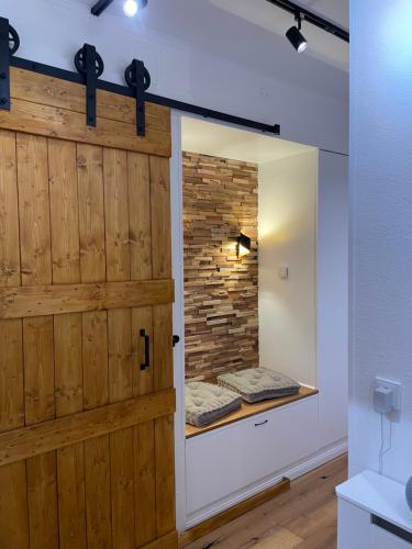 a sliding barn door in a bathroom with a brick wall at Apartment Beletage Bad Harzburg in Bad Harzburg