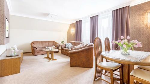 a living room with a couch and a table at Hotel Sylwia in Sośnicowice