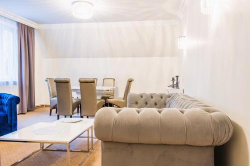 a living room with a couch and a table at Hotel Sylwia in Sośnicowice