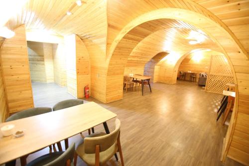 Cette chambre dispose d'une table, de chaises et d'un plafond en bois. dans l'établissement Pilot hotel Baku center, à Baku