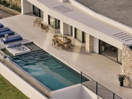 an aerial view of a house with a swimming pool at Verdante Villas , Quintessential SeaView Living, By ThinkVilla in Agios Nikolaos