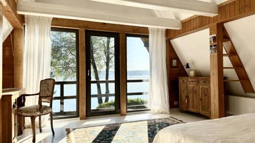 a bedroom with a bed and a large window at Lustro Wody in Osiek