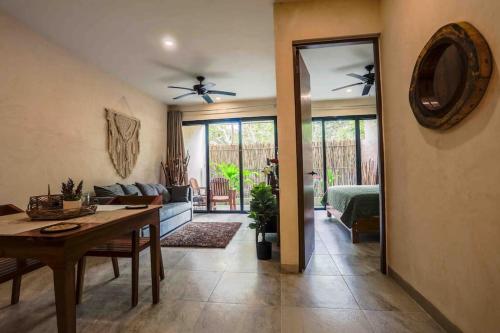a living room with a table and a dining room at MICAELA apartment pool AC next to the lagoon in Bacalar