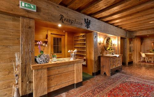 a kitchen with a counter in a room with wooden walls at Hotel Schwarzer Adler in Hippach