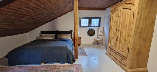 a bedroom with a bed and a wooden ceiling at Lustro Wody in Osiek