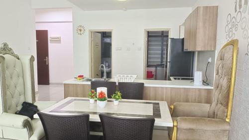 a kitchen and living room with a table and chairs at PALAZIO CONDO (MOUNT AUSTIN) in Johor Bahru