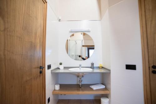 a bathroom with a sink and a mirror at Mas el Coll in El Gurb