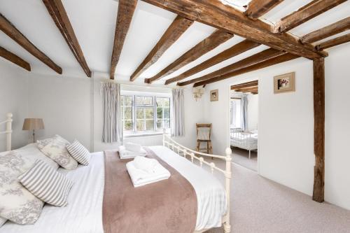 a bedroom with two beds and a window at The Milkhouse Cottage by Huluki Sussex Stays in Ashurst