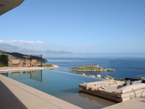 a swimming pool with a view of the ocean at Verdante Villas in Agios Nikolaos
