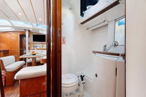 a bathroom with a toilet and a table on a boat at Pato Lucas Sail Boat in San Sebastián de la Gomera
