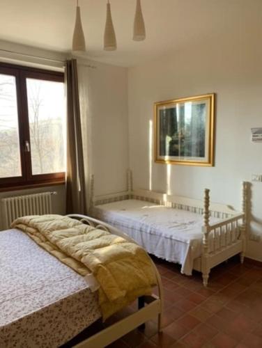 a bedroom with two beds and a window at [Appartamento Girasole] in Varzi