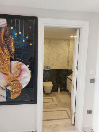 a bathroom with a painting of a bathroom with a toilet at Casa Hills in Alanya
