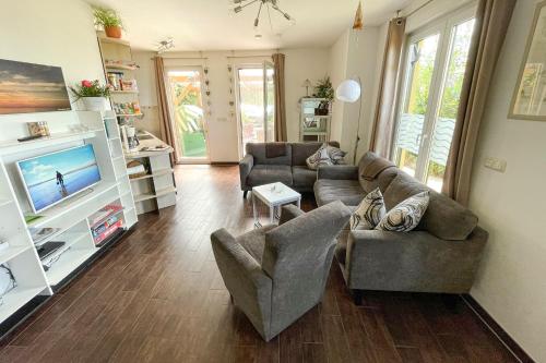 a living room with two couches and a television at Ferienhaus am kleinen Hafen in Neuendorf
