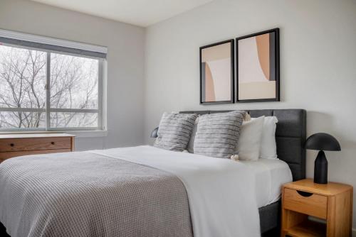 a white bedroom with a bed and a window at Blueground Queen Anne laundry nr shopping SEA-705 in Seattle