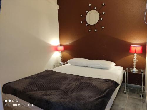 - une chambre avec un lit, deux lampes et un miroir dans l'établissement Appart 143, Port Soleil au village naturiste, au Cap d'Agde