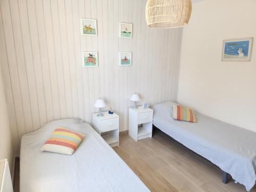 Ένα ή περισσότερα κρεβάτια σε δωμάτιο στο Séjour apaisant avec piscine à Andernos-les-Bains