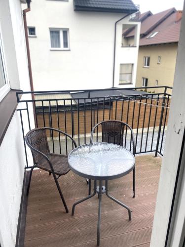 a table and two chairs on a balcony at Willa Karwia in Karwia