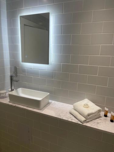 a bathroom counter with a sink and a mirror at The Rugby Hotel in Rugby