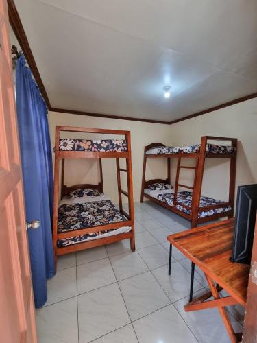 a room with two bunk beds and a table at Aikaterinis in San Narciso