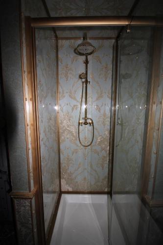 a shower with a light on a wall at Chimera House in Brighton & Hove