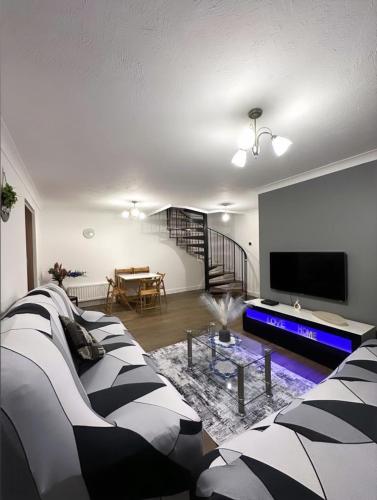 a living room with a couch and a flat screen tv at Md Stays in London