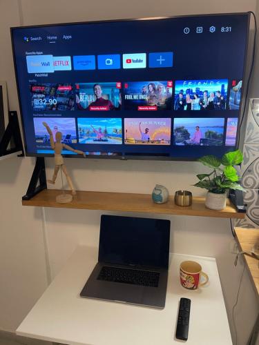 a computer monitor and a laptop on a desk at Spring-shell in Beer Sheva