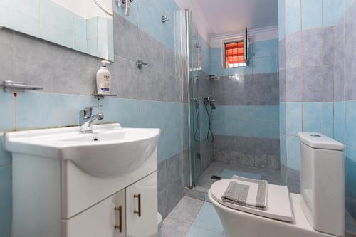 a bathroom with a sink and a toilet and a shower at Tinas Village Free Transport from/to the airport in Spáta