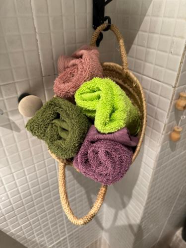 a basket of towels hanging on a wall at La Fantàstica de la Part Alta in Tarragona