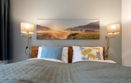 a bedroom with a bed with two lamps on it at Apartment Sonnleitner in Kötschach