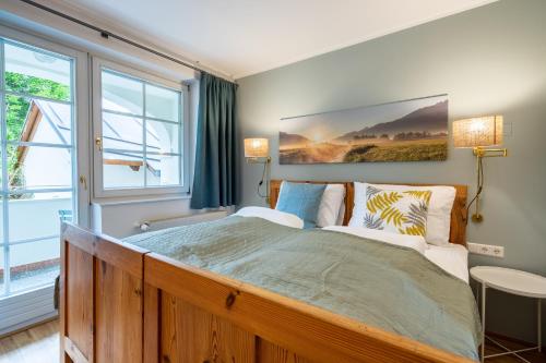 a bedroom with a large bed and a window at Apartment Sonnleitner in Kötschach