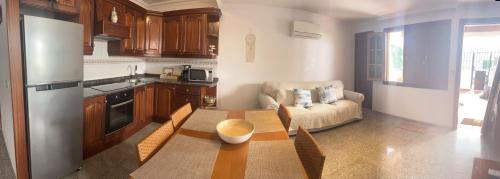 a kitchen with a table and a couch in a room at Playa Chica apartment in Puerto del Carmen