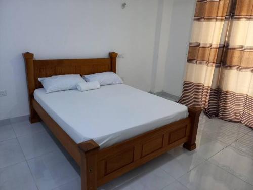 a bed in a room with a wooden frame at 1 bedroom with 2 beds, Mombasa Kisimani, Nyali in Mombasa