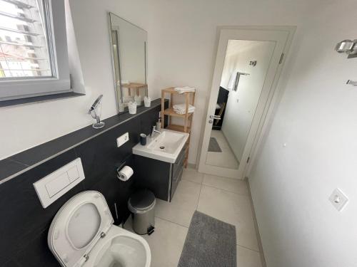 a bathroom with a toilet and a sink at Amt11 - Relax / family / home-office in Bad Wörishofen