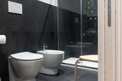 a bathroom with a toilet and a glass shower at Roma Mia in Trastevere in Rome