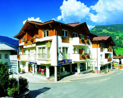 a building with a sign on the side of it at Landhotel Zenzerwirt in Hippach