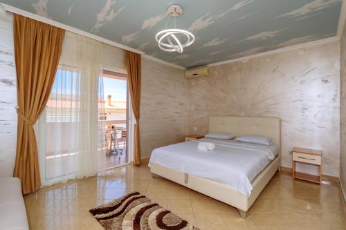 a bedroom with a bed and a room with a window at Ani Lux in Dobra Voda