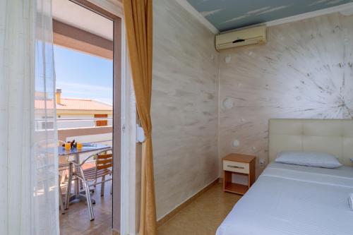 a bedroom with a bed and a balcony at Ani Lux in Dobra Voda