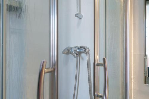 a shower with a shower head in a bathroom at Apartamento junto a las Setas de Sevilla in Seville