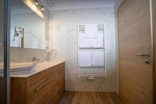 a bathroom with a sink and a mirror at Alpenhof Chalets in Gerlos