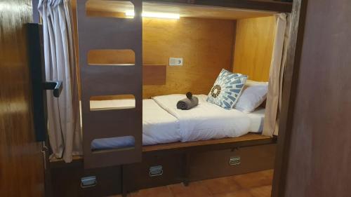 ein Schlafzimmer mit einem Bett mit einem ausgestopften Tier darauf in der Unterkunft Kartika Lodge in Bengkok