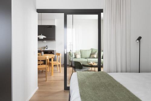 a bedroom with a living room and a dining room at Noli Otaniemi in Espoo