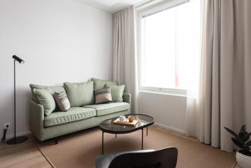 a living room with a couch and a table at Noli Otaniemi in Espoo