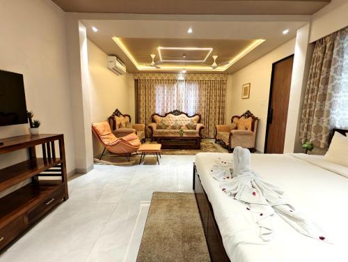 a bedroom with a bed and a living room at The Sky Imperial Sethji Ni Wadi in Indore